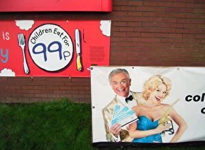 Images Dated 28th December 2004: Advertisements to lure customers of all ages, motorway service station brick wall with posters