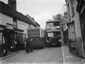 A butcher van and the number 21 bus squeeze past each other in the tight Farningham A butcher van and the number 21 bus squeeze past each other in the tight Farningham