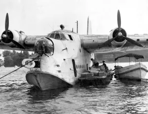 German workmen unload food from a British Royal Air Force flying boat, one of ten German workmen unload food from a British Royal Air Force flying boat, one of ten