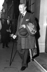Harold Macmillan with walking stick and cigar leaving Claridges Hotel, West London Harold Macmillan with walking stick and cigar leaving Claridges Hotel, West London