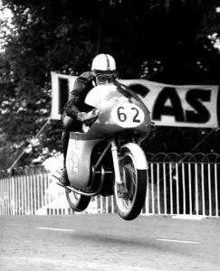 John Surtees MV machine is clear of the ground as he roars over Ballaugh Bridge John Surtees MV machine is clear of the ground as he roars over Ballaugh Bridge