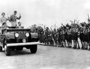 Queen Elizabeth II and the Duke of Edinburgh wave smiling acknowlegements of the Queen Elizabeth II and the Duke of Edinburgh wave smiling acknowlegements of the