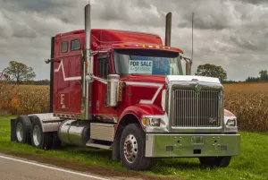 A red 6x4 Intaenational eagle semi tracter unit for sale by the raod side in rural A red 6x4 Intaenational eagle semi tracter unit for sale by the raod side in rural