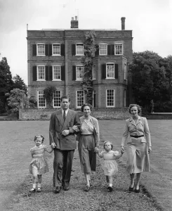 Prints of Taking a morning stroll in the garden of Ayot House, their home at Ayot St Lawrence, Herts, is ex-King Michael of Romania, his wife (formerly Princess Anne of Boubon Palma ) Romania Prints: Print of a family strolling in the garden at Ayot House
