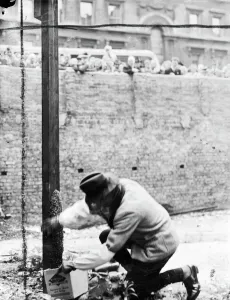 A swarm of bees which settled at the foot of a pole on a bomb site in Victoria Street A swarm of bees which settled at the foot of a pole on a bomb site in Victoria Street