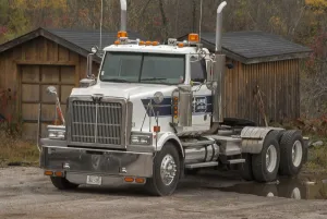 A white 6 x4 Western star tractor unit parked up at a rural Ontario timber yard A white 6 x4 Western star tractor unit parked up at a rural Ontario timber yard