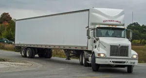 White International 6x4 semi tracter with a white twin axle box trailer turns right White International 6x4 semi tracter with a white twin axle box trailer turns right