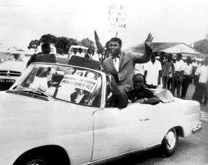World Heavyweight Boxing Champion Cassius Clay rides in an open sports car as he World Heavyweight Boxing Champion Cassius Clay rides in an open sports car as he