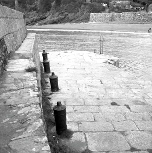 Harbour wall with cannon bollards, Polkerris, Tywardreath, Cornwall. 1976 Harbour wall with cannon bollards, Polkerris, Tywardreath, Cornwall. 1976
