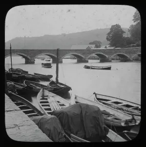 Prints of View from the Quay, East Looe. A number of small boats are moored in the foreground. The glass lantern slide is from a series and is numbered 56. Photographer: Unknown Looe Prints: Print of Looe Bridge, East Looe, Cornwall, circa 1900