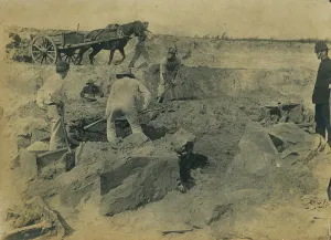 Workmen uncovering a group of cists at the excavation site of the Iron Age cemetery at Workmen uncovering a group of cists at the excavation site of the Iron Age cemetery at