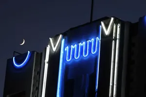 Prints of A waxing crecent moon sets over neon lights on an Art Deco style renovated hotel on Ocean Drive in South Miami Beach, Florida 26 September 2006 Embrace The Elegance: Art Deco Poster Art Collection: Print of a waxing crescent moon over an Art Deco building on Miami Beach