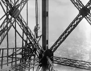 Print of a worker climbing the Eiffel Tower in Paris, 1930s