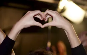 A heart shape is formed by a participant of the Feminist Initiative election night A heart shape is formed by a participant of the Feminist Initiative election night