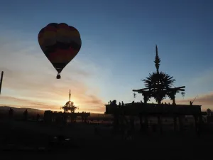 Hot air balloon flies over the Solar Temple at dawn at the Symbiosis Oregon Eclipse Festival Hot air balloon flies over the Solar Temple at dawn at the Symbiosis Oregon Eclipse Festival
