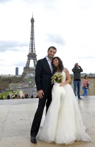 A mixed American and Roumanian newly married couple poses in front of the Eiffel tower on March 21 A mixed American and Roumanian newly married couple poses in front of the Eiffel tower on March 21