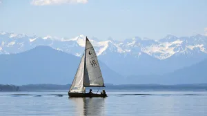 Sail boat on lake Starnberger See against Alps panorama Sail boat on lake Starnberger See against Alps panorama