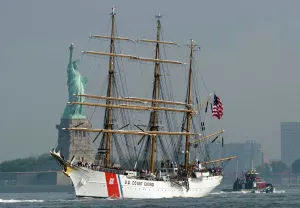 Prints of The US Coast Guard Tall Ship Eagle sails past the Statute of Liberty May 23, 2012 in New York. The tall ship is participating in Fleet Week events in New York New York Prints: US Coast Guard Tall Ship Eagle Print