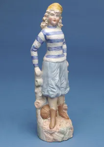Bisque figure of a girl footballer in blue and white striped kit, c.1890s (ceramic) Bisque figure of a girl footballer in blue and white striped kit, c.1890s (ceramic)
