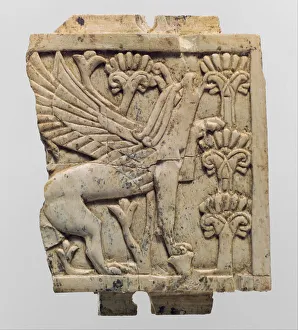 Furniture plaque carved in relief with a griffin in a floral landscape, c Furniture plaque carved in relief with a griffin in a floral landscape, c