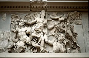 Greek Art: representation of Athena catching Giant Alcyonee by the hair. Frieze of the Gigantomachia from the altar of Greek Art: representation of Athena catching Giant Alcyonee by the hair. Frieze of the Gigantomachia from the altar of