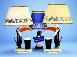 A lampbase modelled as a toucan beside a pint glass, (carltonware painted in colours) A lampbase modelled as a toucan beside a pint glass, (carltonware painted in colours)