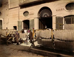 Rows of maccheroni dryers in front of a factory in Torre Annunziata. The scene is enlivened by the employees of Rows of maccheroni dryers in front of a factory in Torre Annunziata. The scene is enlivened by the employees of