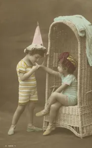 Young boy kissing the hand of a little girl (coloured photo) Young boy kissing the hand of a little girl (coloured photo)