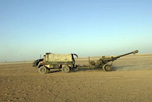 A 105mm light gun being towed by a Pinzgauer all-terrain vehicle A 105mm light gun being towed by a Pinzgauer all-terrain vehicle