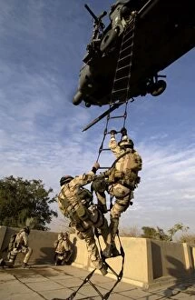 Images Dated 20th December 2004: Air Force pararescuemen are extracted by an HH-60G Pave Hawk helicopter