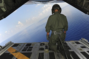 Airman observes the waters of the Gulf of Mexico from a C-130 Hercules Airman observes the waters of the Gulf of Mexico from a C-130 Hercules