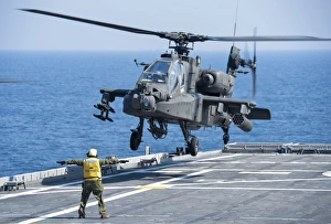 An Army AH-64D Apache helicopter prepares to land aboard USS Ponce An Army AH-64D Apache helicopter prepares to land aboard USS Ponce