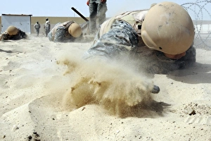 Army soldier pulls himself through a sandpit on a Defender Challenge course Army soldier pulls himself through a sandpit on a Defender Challenge course