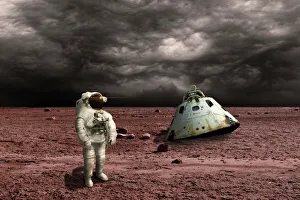An astronaut surveys his situation after being marooned on a barren planet An astronaut surveys his situation after being marooned on a barren planet