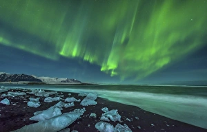 Aurora borealis over the ice beach near Jokulsarlon, Iceland Aurora borealis over the ice beach near Jokulsarlon, Iceland