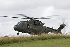 An AW101 Merlin helicopter of the Royal Air Force lands in a field An AW101 Merlin helicopter of the Royal Air Force lands in a field
