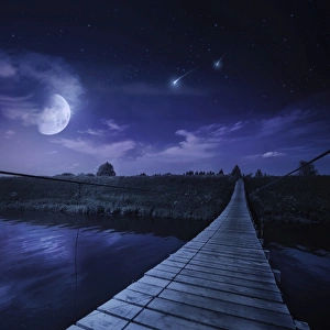 A bridge across the river at night against starry sky, Russia A bridge across the river at night against starry sky, Russia