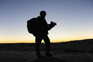 A British soldier on patrol as the Sun rises A British soldier on patrol as the Sun rises