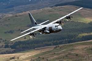 A C-130 Hercules of the Royal Air Force flying over North Wales A C-130 Hercules of the Royal Air Force flying over North Wales