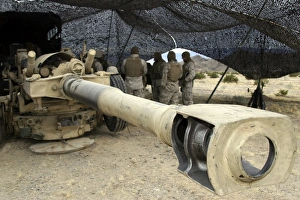 Cannoneers take advantage of some down time behind their M198 Towed Howitzer Cannoneers take advantage of some down time behind their M198 Towed Howitzer