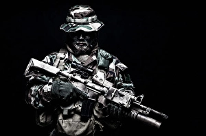 Dark Background Portraits Prints: Commando soldier in battle uniform