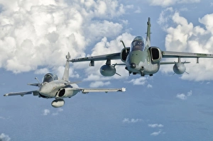A Dassault Rafale of the French Air Force flys alongside an Embraer A-1B of the Brazilian A Dassault Rafale of the French Air Force flys alongside an Embraer A-1B of the Brazilian