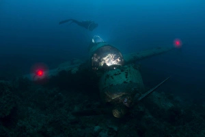 Diver exploring the wreck of a Japanese Navy Seaplane in Palau, Micronesia Diver exploring the wreck of a Japanese Navy Seaplane in Palau, Micronesia