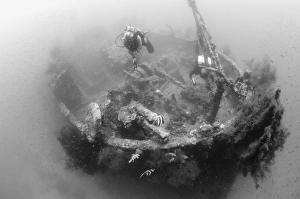 Divers explore the wreck of a Japanese Maru warship, Solomon Islands Divers explore the wreck of a Japanese Maru warship, Solomon Islands