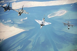 Emirati F-16s, an Emirati Mirage 2000, and a Pakistani F-7 fly in formation during Emirati F-16s, an Emirati Mirage 2000, and a Pakistani F-7 fly in formation during