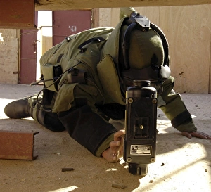 An EOD member places an x-ray machine near an Improvised Explosive Device An EOD member places an x-ray machine near an Improvised Explosive Device