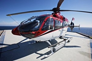 Eurocopter EC135 utility helicopter on the helipad of an oil rig Eurocopter EC135 utility helicopter on the helipad of an oil rig