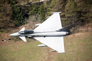 A Eurofighter Typhoon F2 aircraft of the Royal Air Force low flying over North Wales A Eurofighter Typhoon F2 aircraft of the Royal Air Force low flying over North Wales