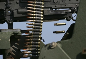 Expended brass falls from a machine gun Expended brass falls from a machine gun