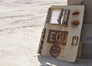 An Explosive Ordnance Disposal logo is painted on an old vehicle door An Explosive Ordnance Disposal logo is painted on an old vehicle door